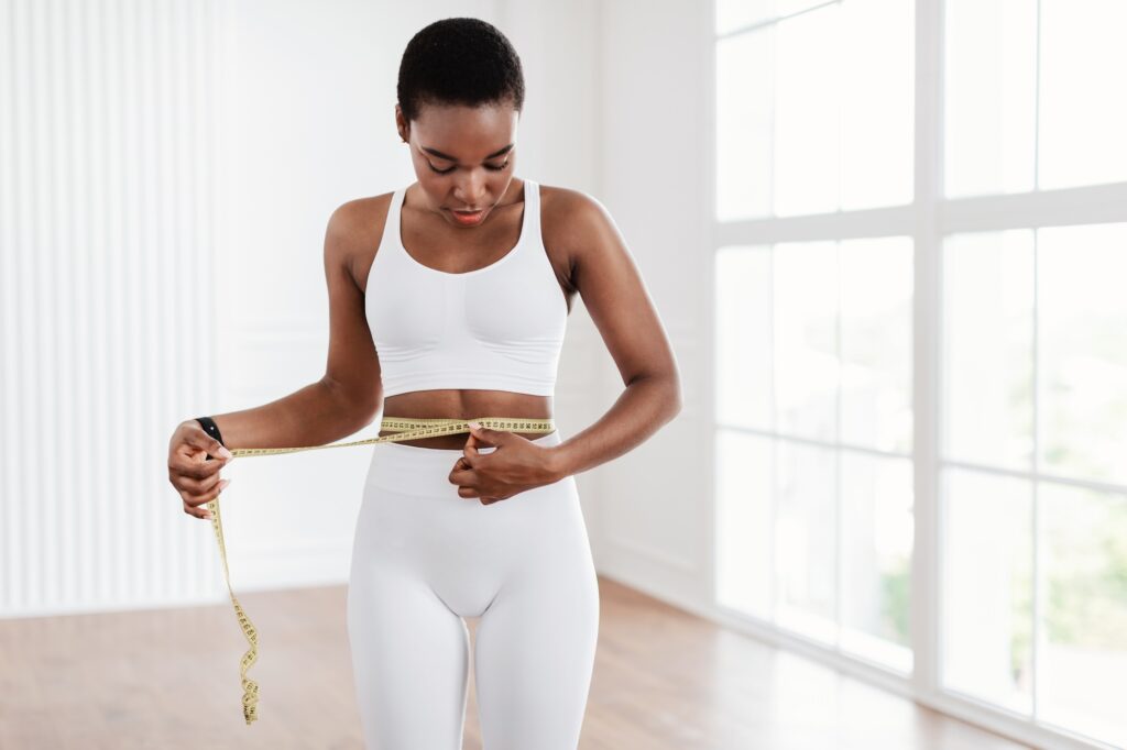 Black Woman Measuring Waist With Tape. Dieting Slimming Concept